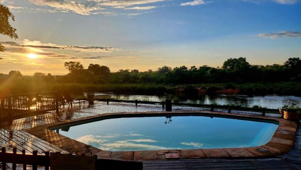 Pool view and sunset at Sabie River Bush Lodge