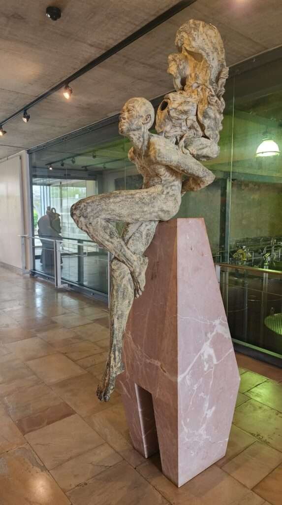 Large stone sculpture of a man at Tokara Wine Estate tasting room